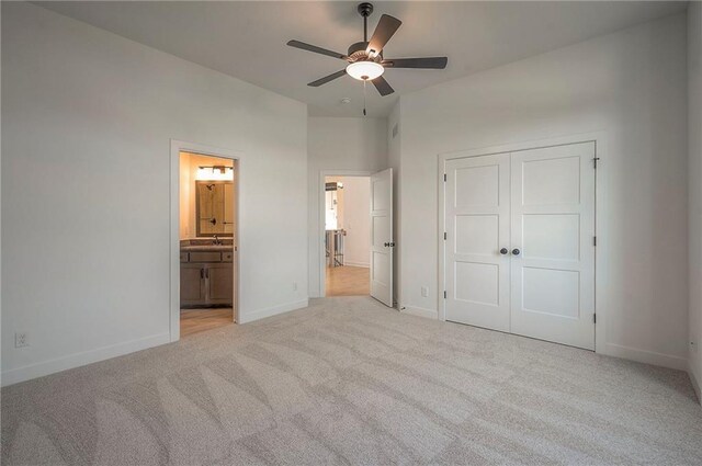 9000 N Clarion Ave, Kansas City, MO 64153 - unfurnished bedroom with carpet flooring, a sink, baseboards, a closet, and connected bathroom