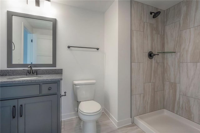 9000 N Clarion Ave, Kansas City, MO 64153 - full bathroom with toilet, vanity, baseboards, and a tile shower
