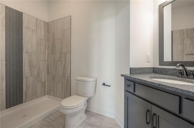 9000 N Clarion Ave, Kansas City, MO 64153 - bathroom featuring toilet, vanity, tiled shower, and baseboards