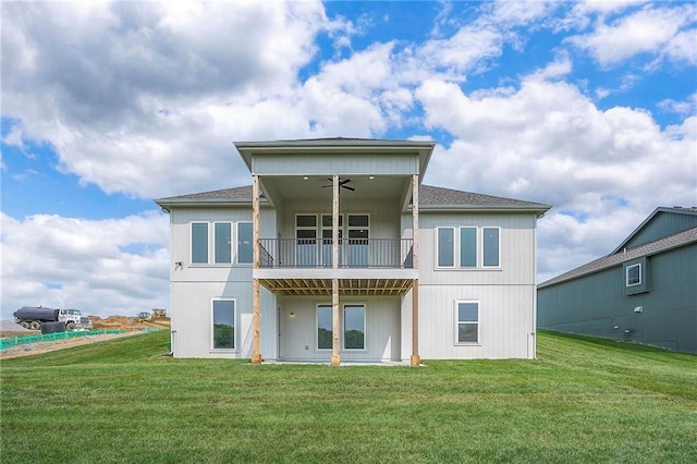 9000 N Clarion Ave, Kansas City, MO 64153 - rear view of house featuring ceiling fan, a lawn, a balcony, and a shingled roof