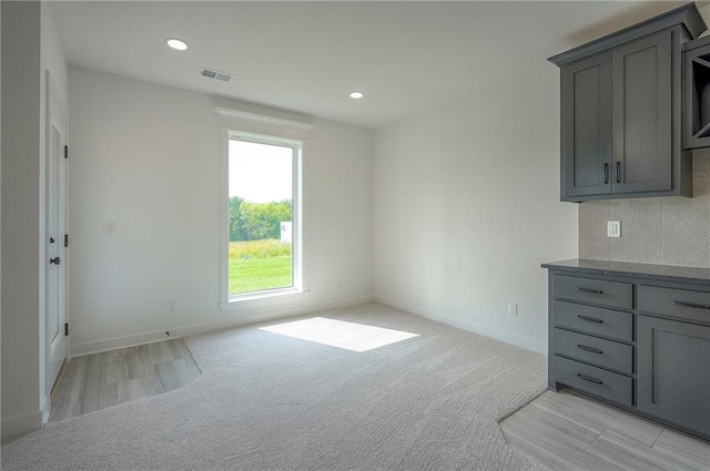 9000 N Clarion Ave, Kansas City, MO 64153 - unfurnished dining area featuring recessed lighting, baseboards, light carpet, and light wood-type flooring