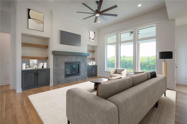 9000 N Clarion Ave, Kansas City, MO 64153 - living area featuring baseboards, a ceiling fan, built in shelves, a fireplace, and recessed lighting