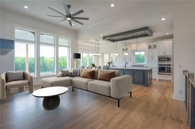 9000 N Clarion Ave, Kansas City, MO 64153 - living area with plenty of natural light, recessed lighting, light wood finished floors, a ceiling fan, and a raised ceiling