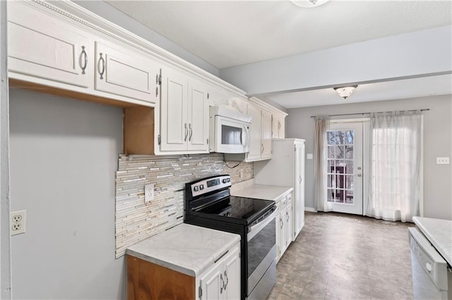 kitchen featuring white appliances, white cabinetry, and decorative backsplash