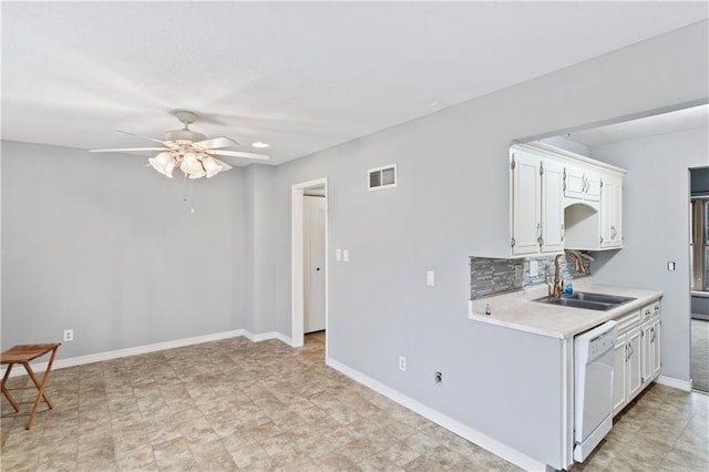 kitchen featuring light countertops, visible vents, white cabinets, a sink, and dishwasher