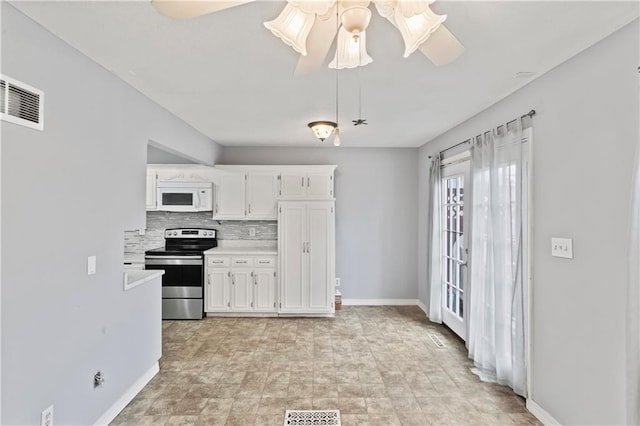 kitchen with light countertops, visible vents, stainless steel electric range oven, and white microwave