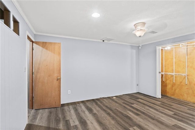 unfurnished bedroom with wood finished floors and crown molding