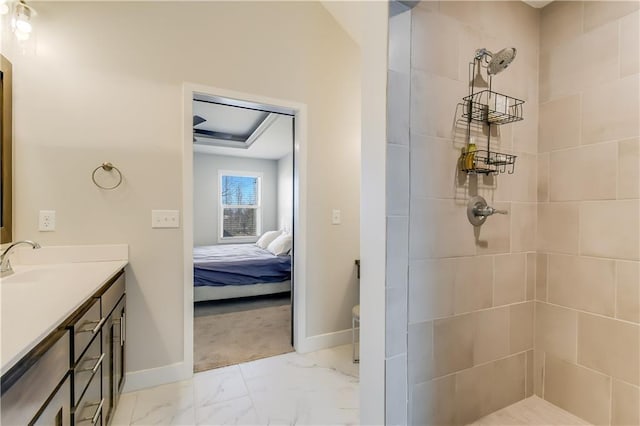 bathroom with vanity and tiled shower