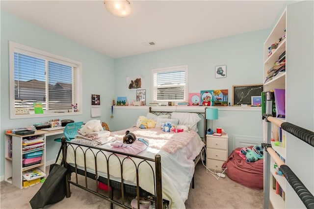 bedroom featuring light carpet