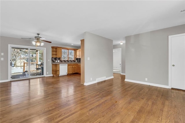 unfurnished living room featuring ceiling fan and light wood-type flooring