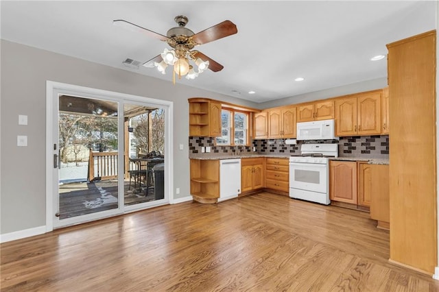 kitchen featuring backsplash, white appliances, ceiling fan, and light wood-type flooring