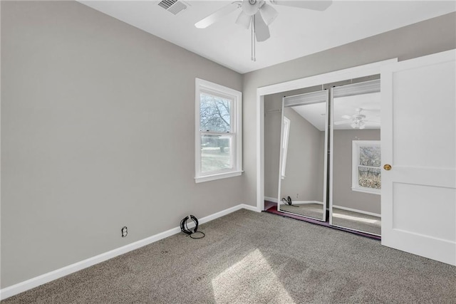 unfurnished bedroom with a closet, ceiling fan, and carpet flooring