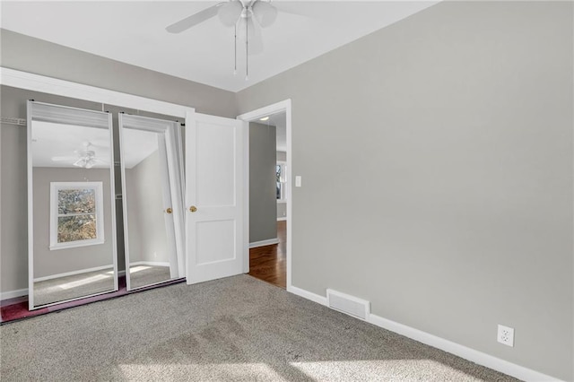 unfurnished bedroom featuring carpet, ceiling fan, and a closet