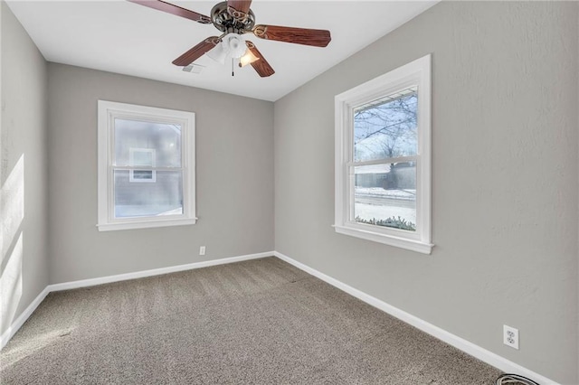 carpeted spare room with ceiling fan