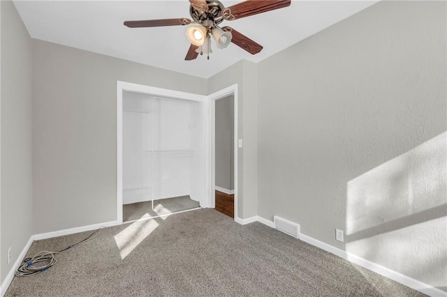 unfurnished bedroom with carpet, ceiling fan, and a closet