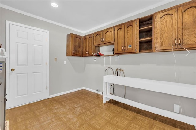 laundry room with cabinets, ornamental molding, hookup for a washing machine, electric dryer hookup, and light parquet flooring