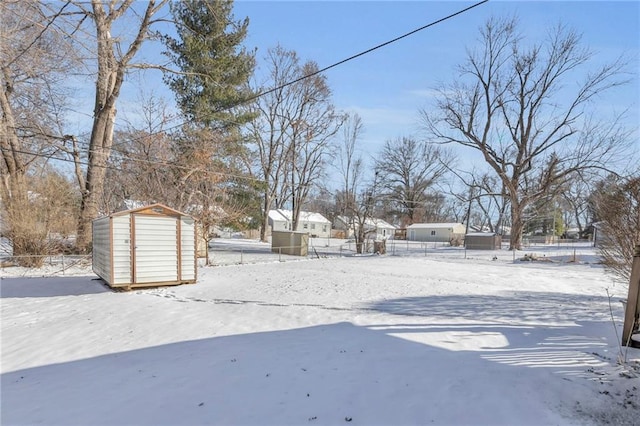 snowy yard with a shed