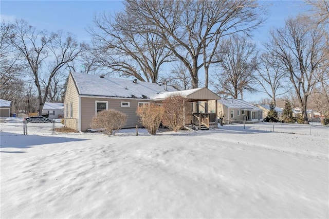 view of snow covered rear of property