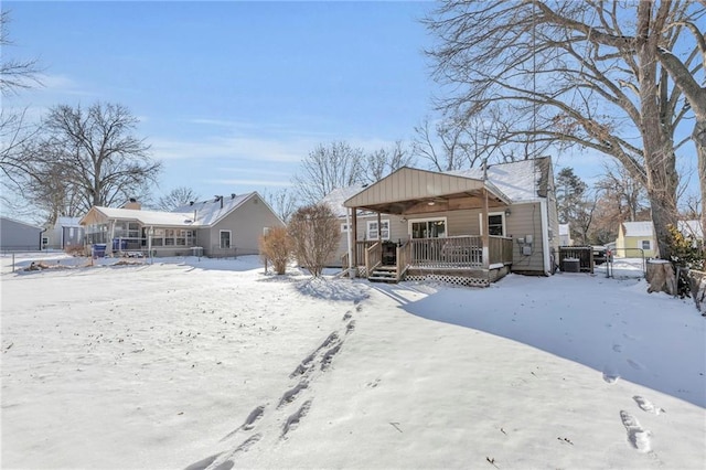 snow covered property with a wooden deck