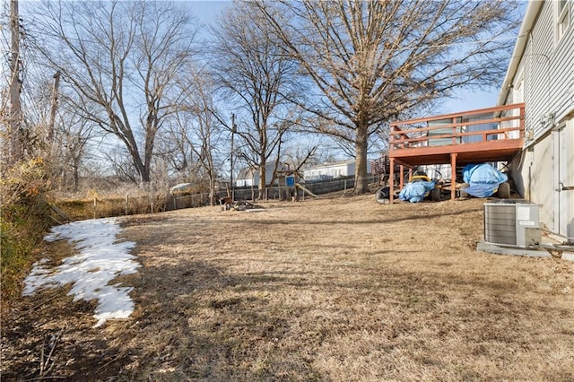 view of yard featuring a wooden deck and central AC