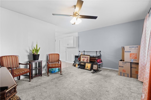 sitting room featuring light colored carpet and ceiling fan