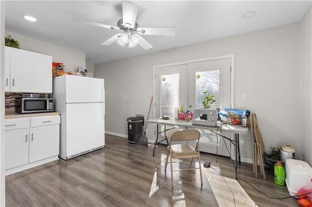 kitchen featuring tasteful backsplash, light hardwood / wood-style floors, white cabinets, and white refrigerator