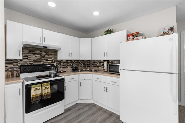 kitchen featuring tasteful backsplash, sink, white cabinets, white fridge, and electric range