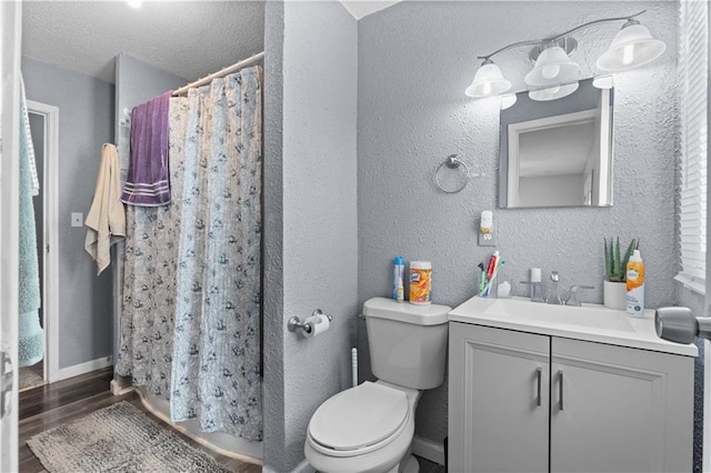 bathroom with vanity, wood-type flooring, toilet, and walk in shower