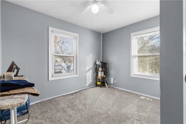 miscellaneous room with ceiling fan and carpet