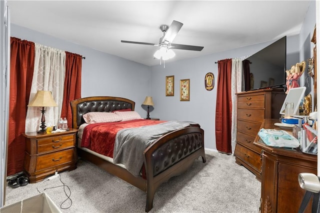 bedroom featuring light carpet and ceiling fan