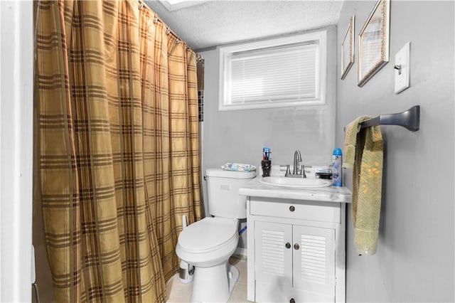 bathroom featuring vanity, tile patterned floors, toilet, and a textured ceiling