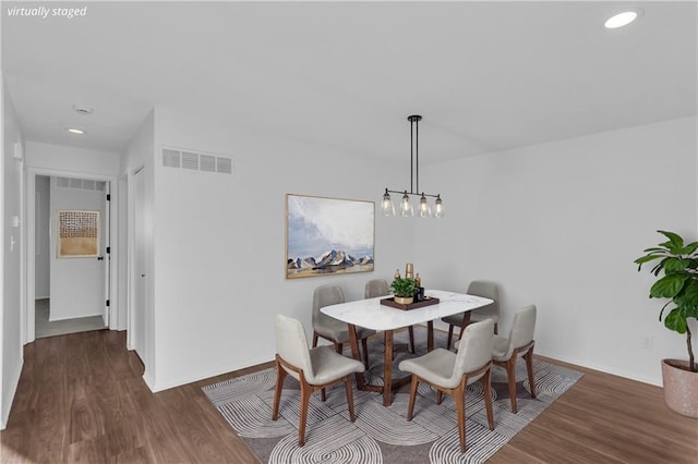 dining space featuring dark wood-type flooring