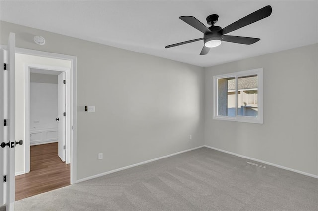 unfurnished room with ceiling fan and light colored carpet