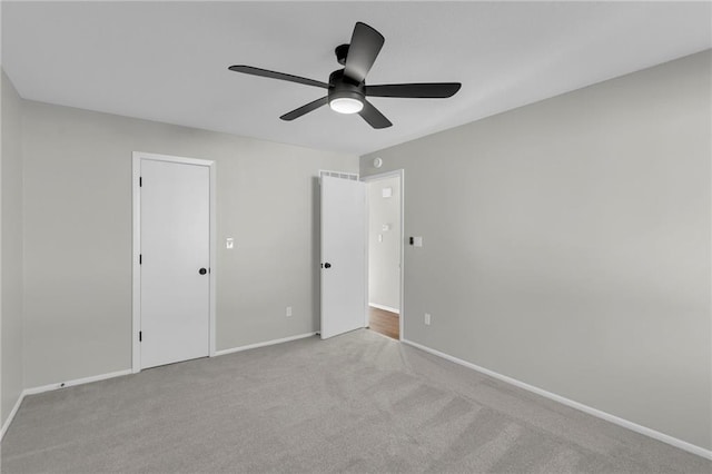 unfurnished bedroom with light carpet and ceiling fan