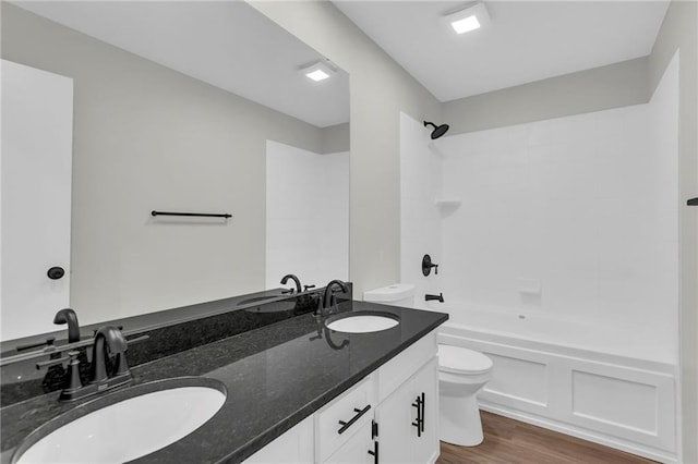 full bathroom featuring vanity, shower / bathing tub combination, wood-type flooring, and toilet