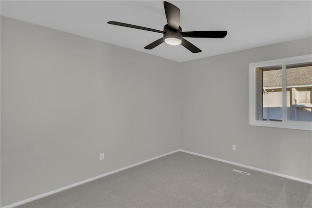 spare room featuring ceiling fan and carpet