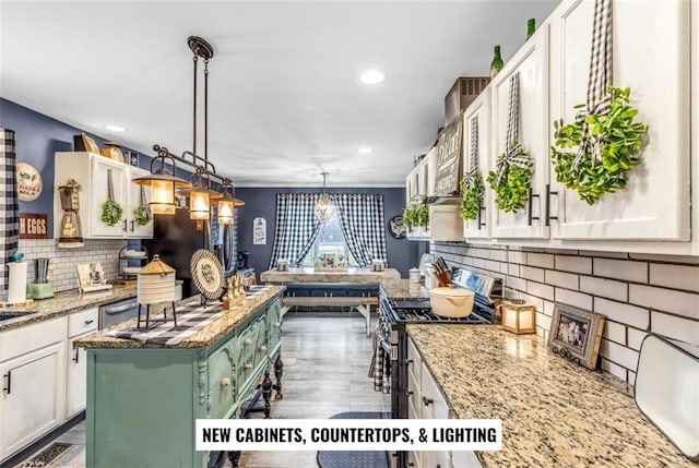 kitchen with white cabinetry, stainless steel range with gas cooktop, a center island, and pendant lighting