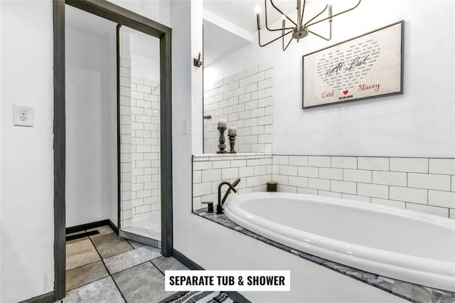 bathroom with plus walk in shower, a chandelier, and tile patterned flooring