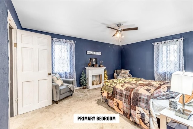 bedroom featuring light colored carpet and ceiling fan