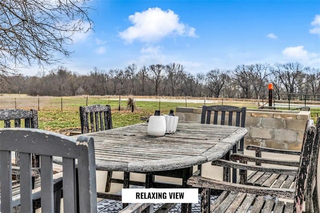 wooden deck with a rural view