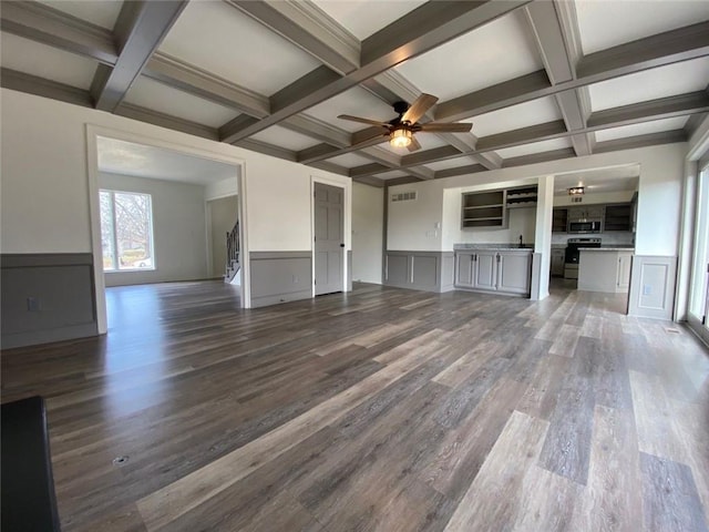 unfurnished living room featuring coffered ceiling and beam ceiling