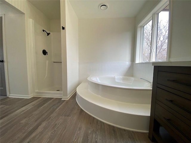 bathroom featuring hardwood / wood-style flooring and shower with separate bathtub