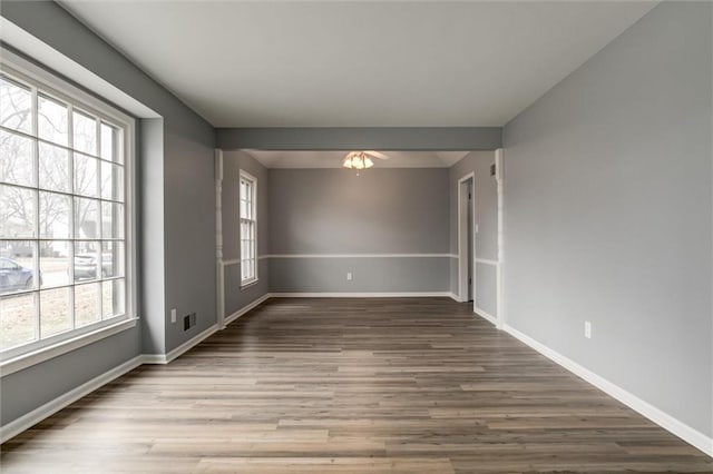 spare room with hardwood / wood-style floors and a wealth of natural light