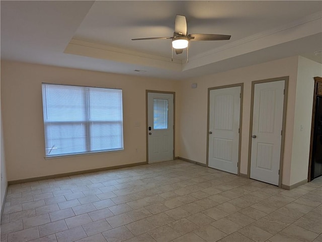 interior space featuring crown molding, a tray ceiling, and ceiling fan