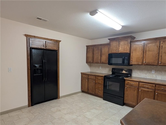 kitchen with black appliances and a textured ceiling