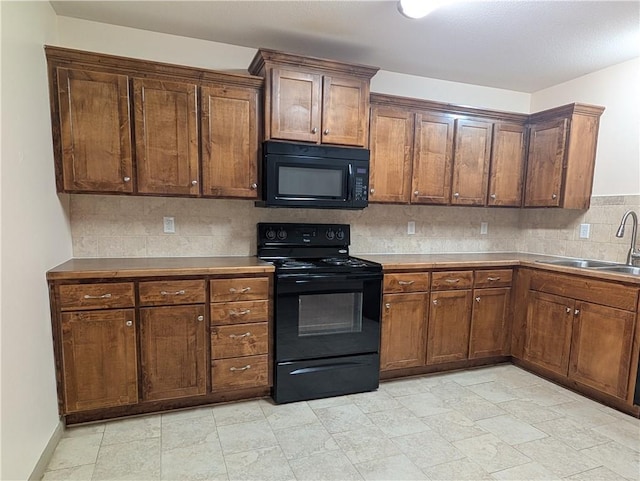 kitchen featuring tasteful backsplash, sink, and black appliances