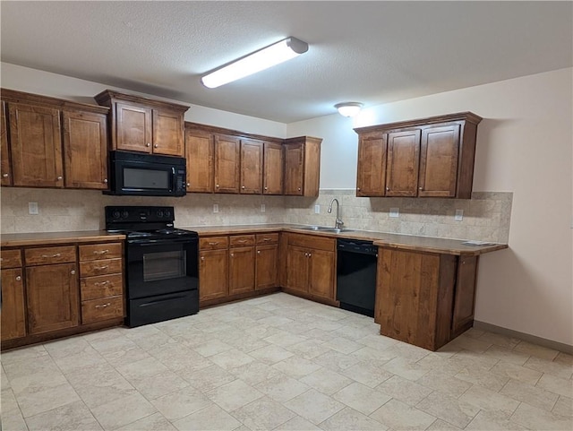 kitchen with tasteful backsplash, sink, a textured ceiling, and black appliances