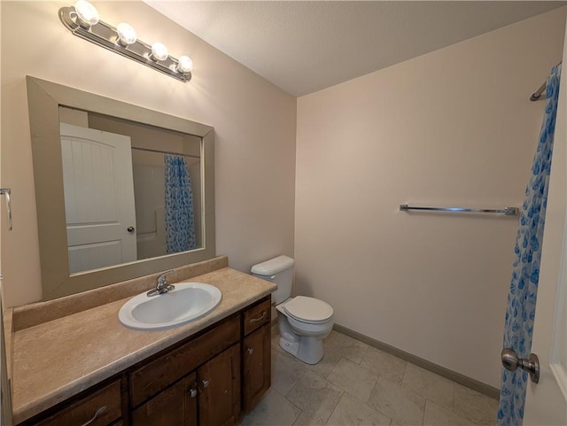 bathroom featuring vanity, a shower with shower curtain, and toilet