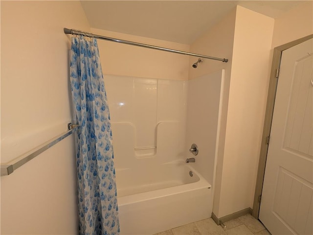 bathroom with shower / tub combo and tile patterned flooring