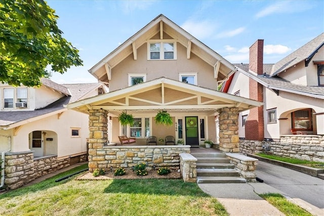 view of front of house with a front lawn and covered porch